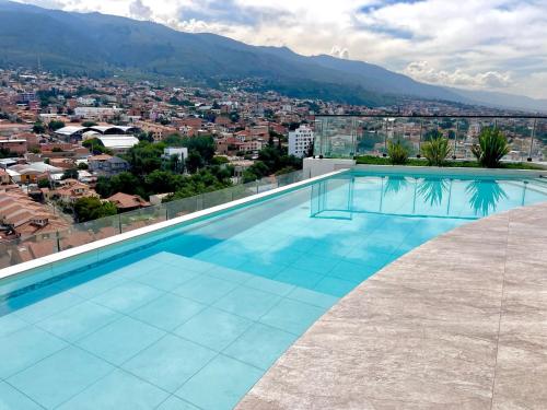 a swimming pool with a view of a city at Moderno garzonier in Cochabamba