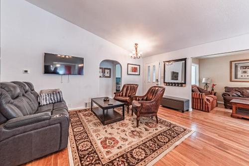 a living room with a couch and a table at Westside Large Home in Colorado Springs