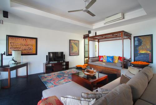 a living room with a couch and a table at Temple Hill Residence Villa in Jimbaran