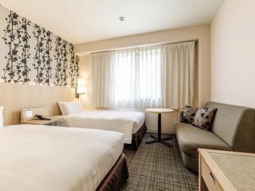 Cama o camas de una habitación en Nishitetsu Resort Inn Beppu
