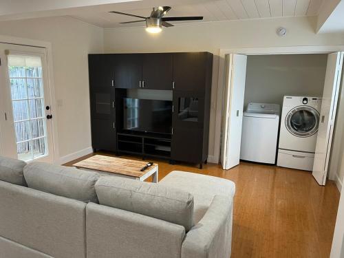 a living room with a couch and a washer and dryer at Stunning, Quiet Vista Retreat Minutes from Beach in Vista