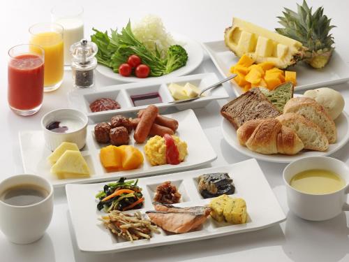 a table with four plates of food on it at Hotel Union in Kagoshima