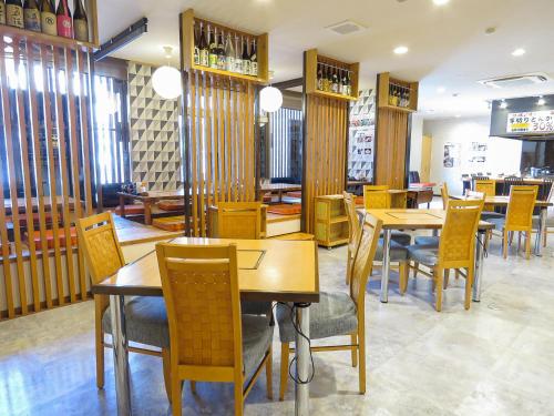 a dining room with wooden tables and chairs at Hotel Union in Kagoshima