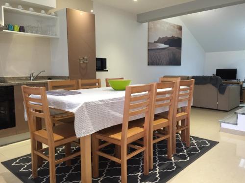 a kitchen and living room with a table and chairs at Gites Des Sablons in Châtillon-sur-Marne