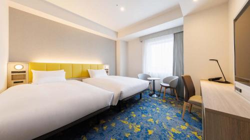 Postel nebo postele na pokoji v ubytování JR-East Hotel Mets Tachikawa