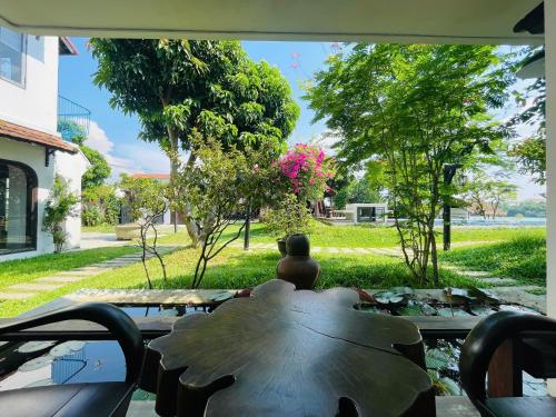 a window view of a table with a large leaf at La Y Riverview in Hue