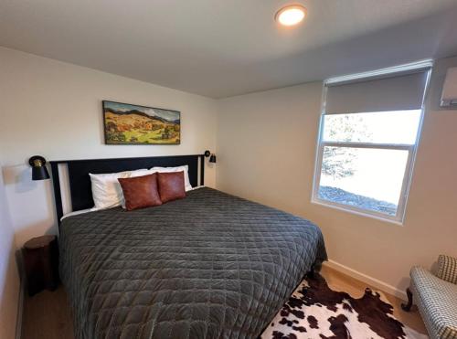 a bedroom with a large bed with a window at Carmel in the Sky in Leakey