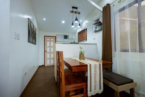 a small dining room with a table and a kitchen at Upper Bliss Homestay in El Nido