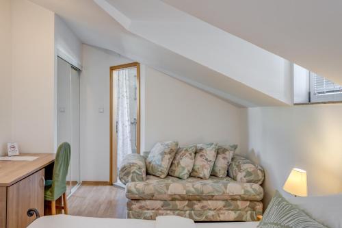 a living room with a couch and a table at Pink Inn in Podstrana