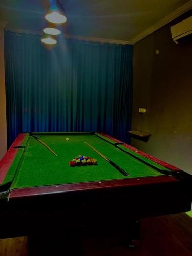 a pool table with cue balls on top of it at The southern Soul Beach Resort -close to calangute beach Managed By Shivam Resort in Calangute