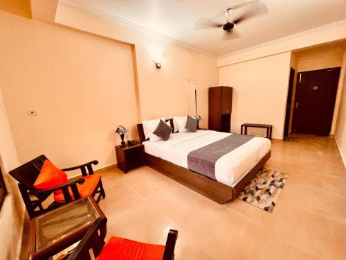 a bedroom with a bed and a chair at The southern Soul Beach Resort -close to calangute beach Managed By Shivam Resort in Calangute