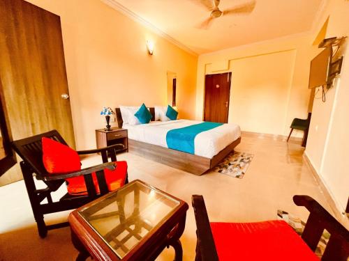 a hotel room with a bed and a chair at The southern Soul Beach Resort -close to calangute beach Managed By Shivam Resort in Calangute