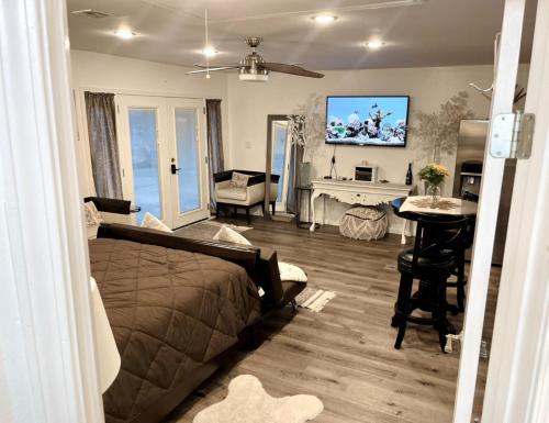 a bedroom with a bed and a living room at Serenity home in Laplace