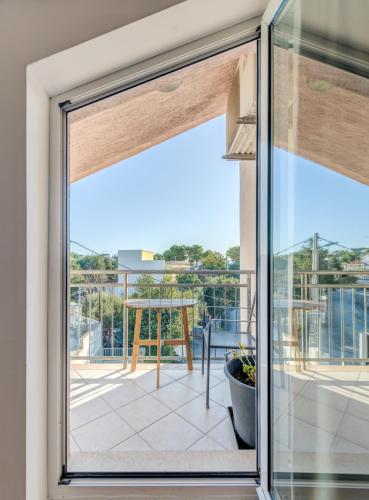 a sliding glass door with a view of a balcony at Pink Inn in Podstrana