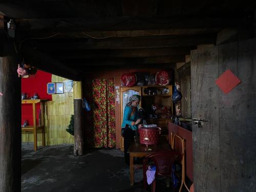 a woman standing in the doorway of a house at Soi Local Guest House in Sa Pa
