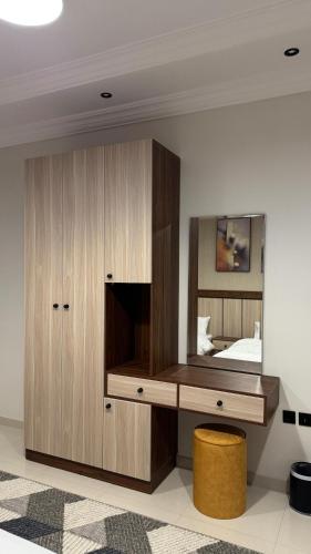 a bedroom with a large wooden cabinet and a mirror at مساكن اهلا وسهلا in Taif