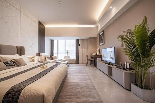 a bedroom with a large bed and a living room at Yufei high-altitude night view Huge-Screen Audiovisual Hotel-Guangzhou Tower Zhujiang New Town Sports West Road Branch in Guangzhou
