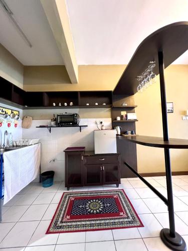 a kitchen with a rug on the floor at The woodland at Selesa Hillhomes Bukit Tinggi Bentong in Bentong