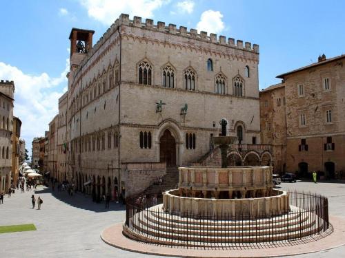 a large building with a fountain in front of it at Holiday Home in Assisi near Mount Subasio in Assisi