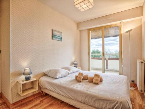 une chambre avec un lit avec deux ours en peluche dessus dans l'établissement Appartement en duplex avec piscine chauffée, idéal pour 6 personnes - FR-1-788-61, à Varaville