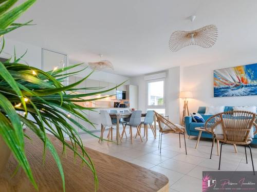 un salon avec une table et des chaises dans l'établissement Spacieux appartement aux Minimes avec parking près de la plage - FR-1-825-66, à La Rochelle