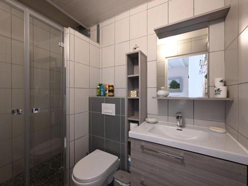 une salle de bain avec un lavabo, des toilettes et un miroir dans l'établissement Charmante Maison de Village au Cœur de La Couarde-sur-Mer - FR-1-434-119, à La Couarde-sur-Mer