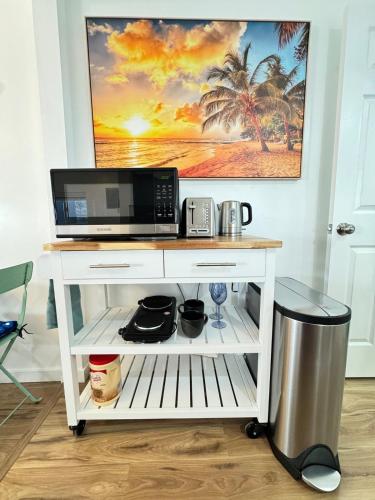 a white desk with a microwave and a computer on it at Cozy Guesthouse - 15 Min to Downtown SD in Chula Vista