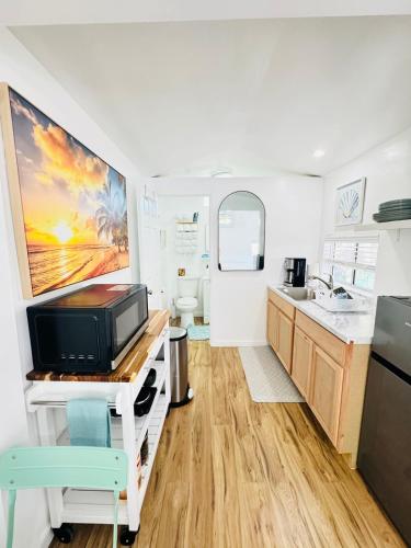 a kitchen with a sink and a refrigerator at Cozy Guesthouse - 15 Min to Downtown SD in Chula Vista