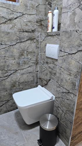 a bathroom with a sink and a mirror on the floor at Guest House Pogradeci in Pogradec