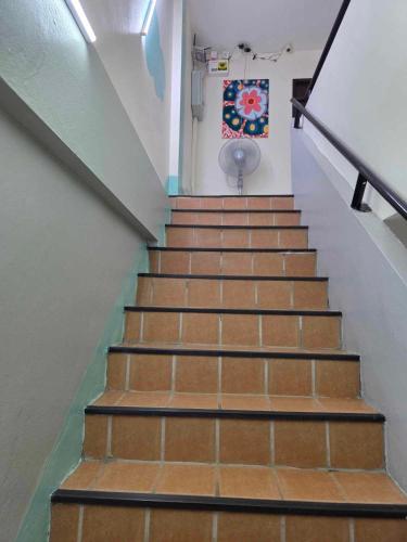 a staircase in a building with brown steps at City Inn Udonthani in Udon Thani
