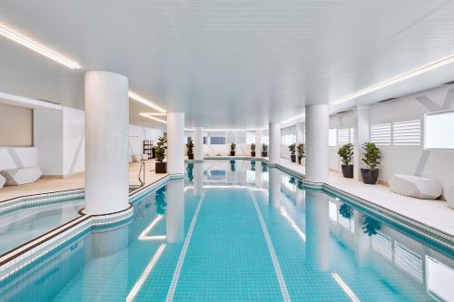 a large swimming pool in a building at Meriton Suites Bondi Junction in Sydney