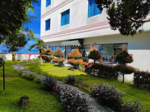 a building with flowers in front of it at Hotel Wisata Indah Sibolga in Sibolga