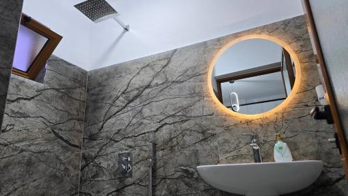 a bathroom with a sink and a mirror at Guest House Pogradeci in Pogradec
