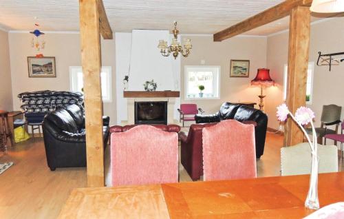 a living room with leather furniture and a fireplace at Stunning Home In Ljungby With Wifi in Bolmstad