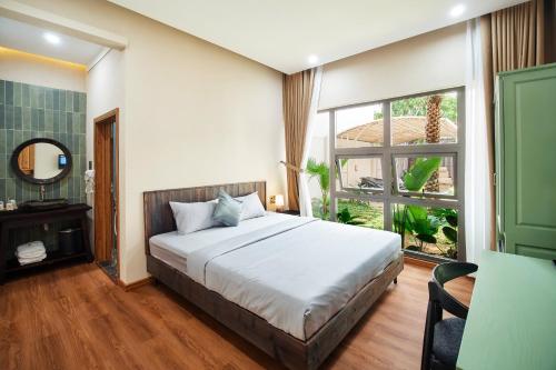 a bedroom with a bed and a large window at MOONLIGHT Homestay & Hotel in Pleiku