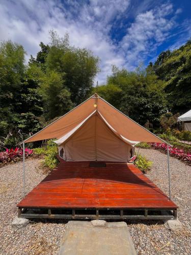 a large tent sitting on top of a bed at Bamboo Sanctuary Pancawati Resort Bogor in Ciherangsating