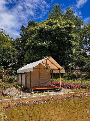 a large tent in a garden with flowers at Bamboo Sanctuary Pancawati Resort Bogor in Ciherangsating