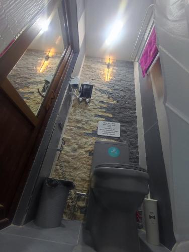 a bathroom with a toilet and a stone floor at Our Village in Ashtarak