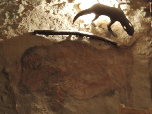 a painting of a cat jumping off a rock at Maison Boutchrafine in Erfoud