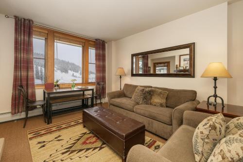 a living room with a couch and a table at Select Unit 2509 - Zephyr Mountain Lodge condo in Winter Park