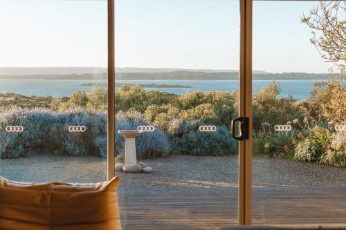 a sliding glass door with a view of a yard at The Summit House in Pelican Lagoon