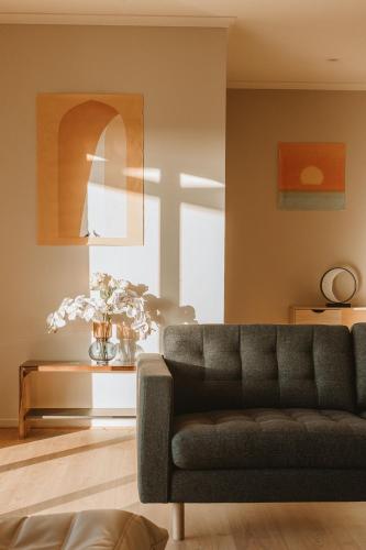 a living room with a couch and a table at The Summit House in Pelican Lagoon