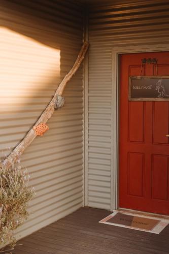 a red door on the side of a house at The Summit House in Pelican Lagoon
