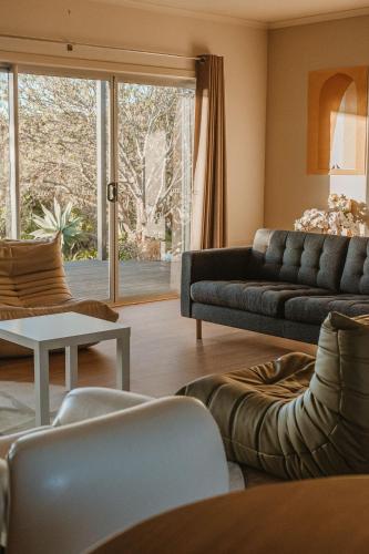 a living room with a couch and a table at The Summit House in Pelican Lagoon