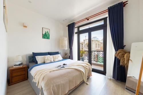 a bedroom with a bed and a large window at Boho Boutique Da Lat - View nhà lồng lãng mạn in Da Thanh