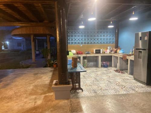 eine große Küche mit einem Kühlschrank und einer Theke in der Unterkunft Dalasone Pool Villa with Stunning Mountain View in Vang Vieng