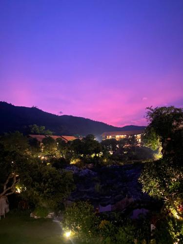 a view of a city at night at Hồ Đá Cổ Thiên Long Resort Hòa Bình in Hòa Bình