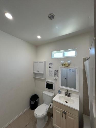 a bathroom with a toilet and a sink at Los Angeles Cozy Vibe in Los Angeles