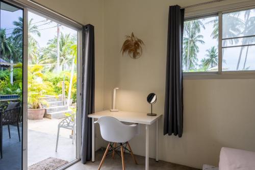 a desk in a room with a window at Sun & Sand Bungalows in Thongsala