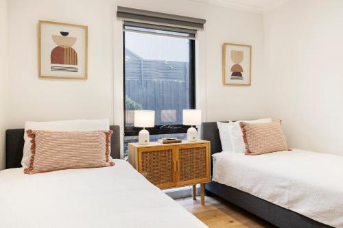 a bedroom with two beds and a window at Bayside Spritz in Hampton in Melbourne
